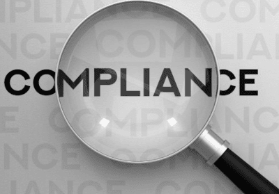 Image of magnifying glass over word compliance